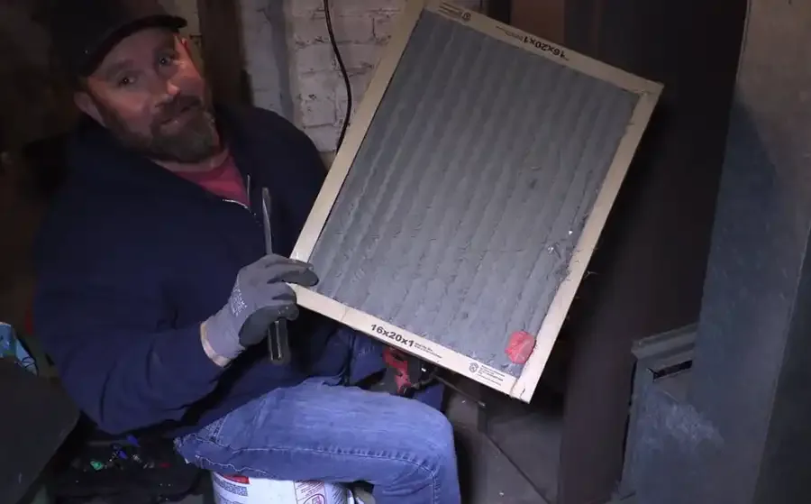 Technician showing dirty furnace filter